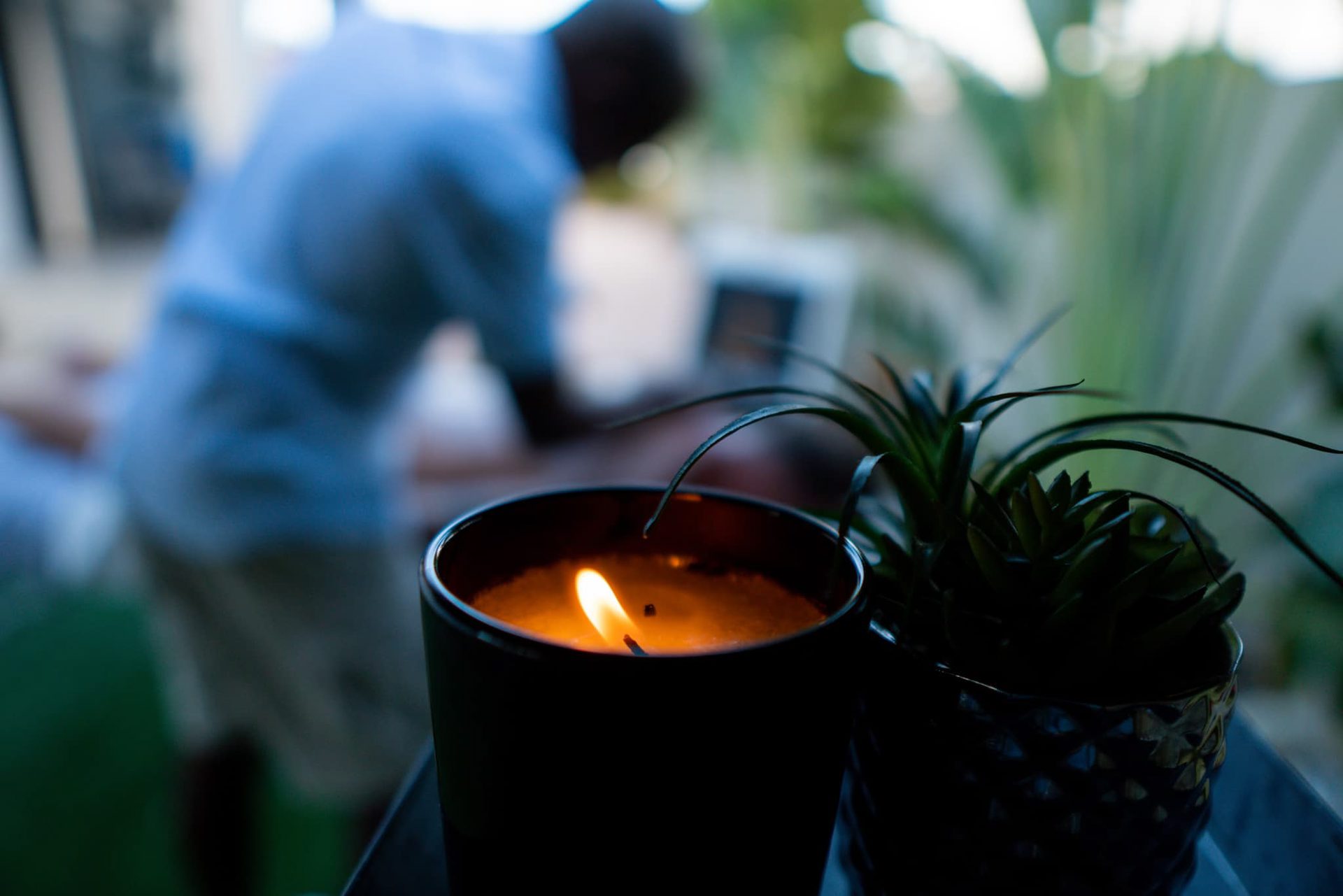 A candle burning during a massage in the garden