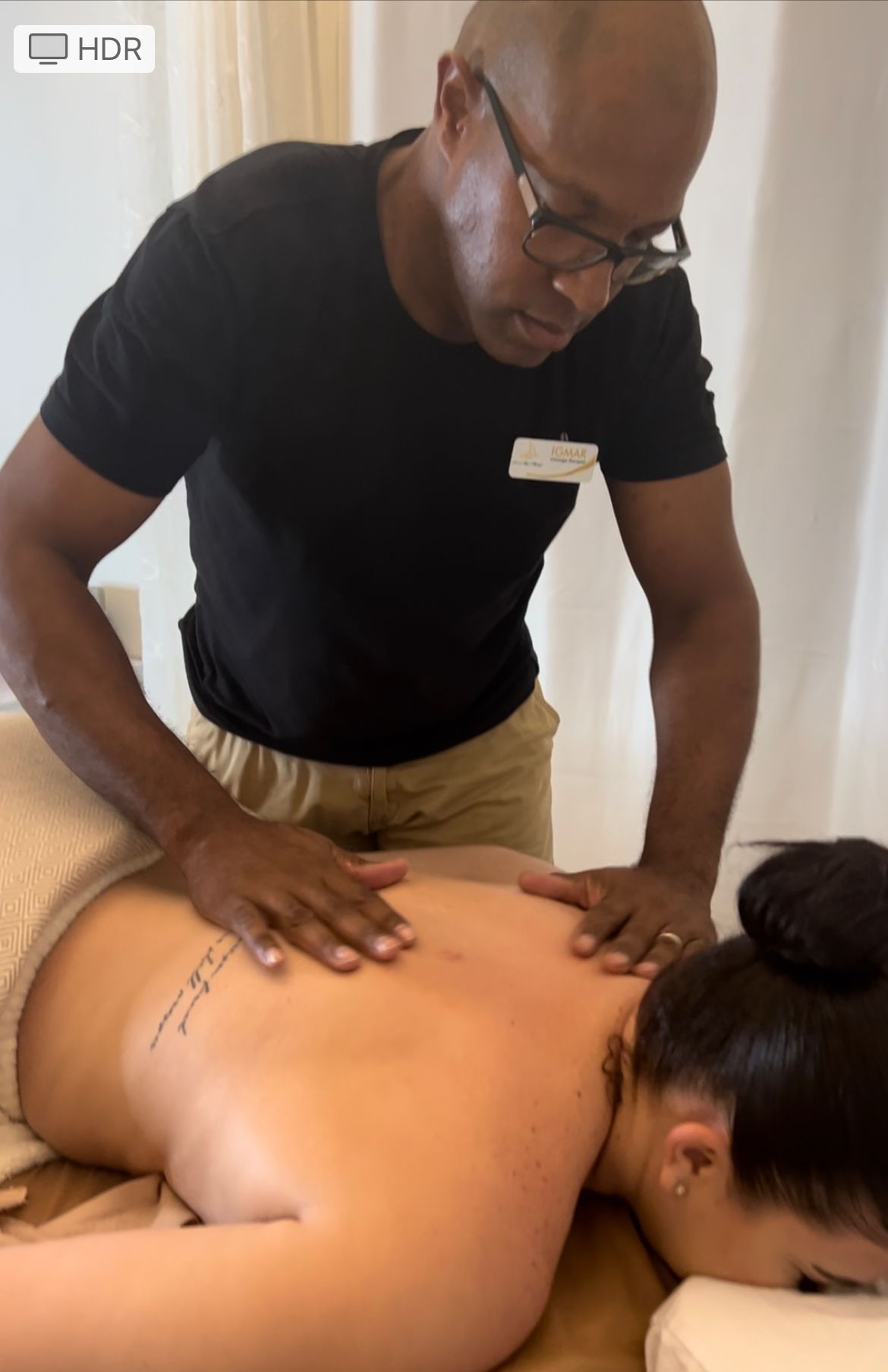 The masseur gives a back massage