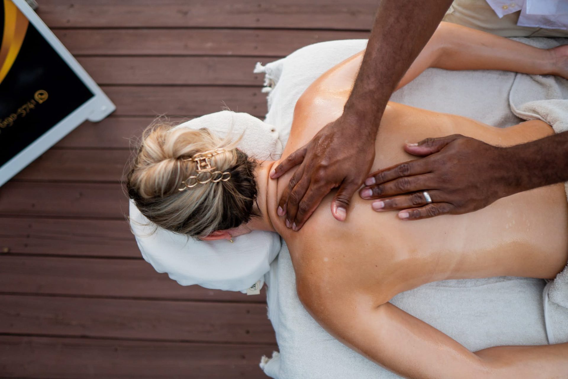 A back massage on the wooden terrace